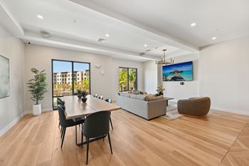 A modern living room with a wooden floor and a large window.